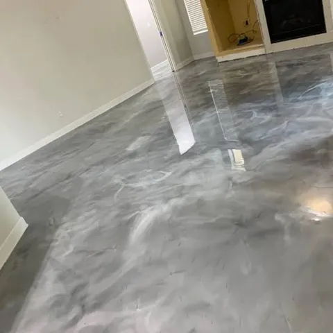 Living room with a fireplace and a light gray and white marbled metallic epoxy floor