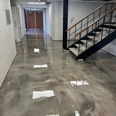 Office hallway and stairwell with a taupe and silver metallic epoxy floor